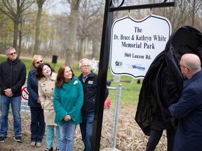 Mayor Drew Dilkens unveils the sign for the Dr. Bruce and Kathryn White Memorial Park, on Monday, April 24, 2023.  The park is located on Lauzon Road, south of the E.C. Row Expressway.