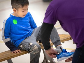 Walkin' in style. Jadd Butalon, a Grade 1 student at St. James Catholic Elementary School, tries on new shoes donated by Operation Warm, a U.S. based charity, on Thursday, April 27, 2023.