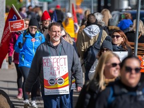 Members of the Public Service Alliance of Canada (PSAC) picket outside the 400 Building at City Hall Square East, on Day 1 of a nationwide general strike, on Wednesday, April 19, 2023.