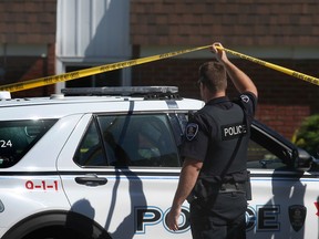 A Windsor Police Service officer is shown outside an apartment building in the 2600 block of Sycamore Drive in Windsor on June 16, 2021. A man was stabbed to death the night before.