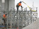 Workers are shown at the Gordie Howe International Bridge construction site in Windsor on March 29, 2023.