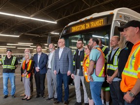 Mayor Drew Dilkens poses for a group photo with Transit Windsor employees after an announcement on transit investment, at Transit Windsor on Friday, April 14, 2023.