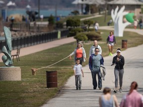 Put away the snow shovels, folks. People enjoy the warm weather along Windsor's waterfront on Monday, April 10, 2023.