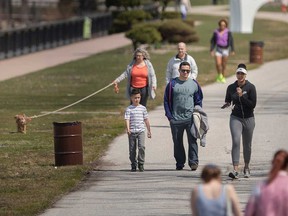 Walkers of Windsor's riverfront enjoy summer-like warmth on April 10, 2023.