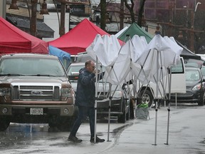 Heavy wind and rain cut the Windsor’s Farmer’s Market opening day short on Saturday, April 1, 2023. Vendor Steve Green packs up his tent due to the rain.