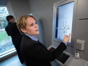 Jacqueline Massi of Accident Support Services International Ltd. demonstrates use of a self-serve kiosk at the Windsor police collision reporting centre on Jefferson Boulevard. Photographed Aug. 4, 2023.