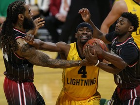 Windsor Express players Justin Moss, left, and Latin Davis try to strip the ball from London's Jeremiah Mordi during Game 1 of the NBL of Canada final. (Derek Ruttan/The London Free Press)