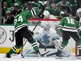 Dallas Stars centre Roope Hintz scores a goal against Seattle Kraken goaltender Philipp Grubauer.