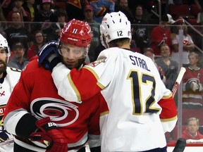 Eric Staal of the Florida Panthers hangs on to his, brother, Jordan Staal of the Carolina Hurricanes.