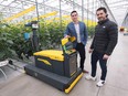 University of Windsor director of research partnerships Tom Schnekenburger, left, and Jem Farms owner Paul J Mastronardi are shown at the HORTECA agricultural research greenhouse in Ruthven on May 2, 2023, with a high-tech autonomous monitoring unit.