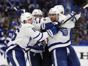Toronto Maple Leafs center John Tavares celebrates with right wing Mitchell Marner after Tavares scored the game-winning goal against the Tampa Bay Lightning during overtime in Game 6 of an NHL hockey Stanley Cup first-round playoff series Saturday, April 29, 2023, in Tampa, Fla.