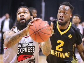 Justin Moss, left, of the Windsor Express battles Cameron Lard of the London Lightning during Game 3 on Tuesday at the WFCU Centre.