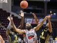 Windsor Express forward Justin Moss, centre,  battles London Lightning centre Kur Jongkuch, left, and guard Jeremiah Mordi during Tuesday's game at the WFCU Centre.