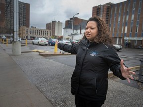 Good fences, good neighbours. Downtown Mission executive director Rukshini Ponniah-Goulin explains on Tuesday, May 2, 2023, where a fence will be set up at the rear of the mission's grounds facing Pelissier Street.