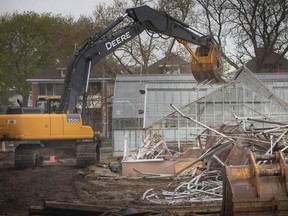An excavator is used in the demolition of the Lanspeary Park greenhouses, on Tuesday, May 2, 2023.