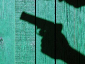 Photo illustration of the shadow of a semi-automatic pistol.