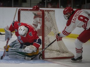 Leamington Flyers' forward Ryan MacPherson tries to get his stick on a loose puck in front of Stratford Warriors' goalie Owen Willmore at the Nature Fresh Farms Recreation Centre.