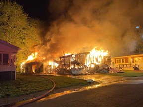 Flames destroy a mobile home on Dana Drive off Viscount Parkway in the town of Essex during the early hours of May 14, 2023.