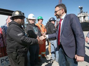 Federal Minister of Transport Omar Alghabra shakes hands with Essex Terminal Railway Company workers at the Port of Windsor on May 26, 2023.