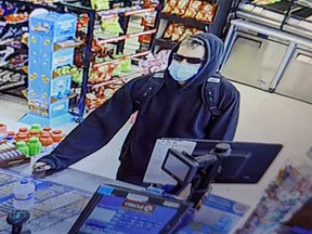 A surveillance camera image of a robbery in progress at a convenience store on Mill Street in Windsor's west end on May 12, 2023.