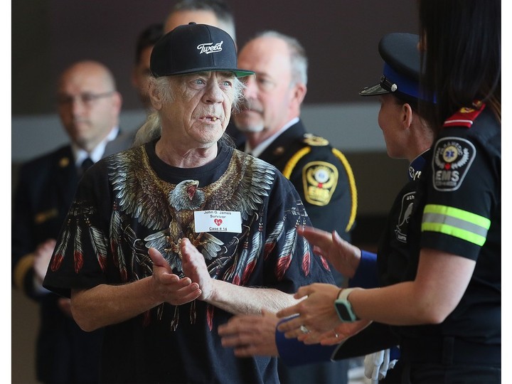  Survivor John G. James applauds first responders during the Essex-Windsor EMS Survivor Day event on Friday, May 26, 2023. James life was saved months earlier thanks to a team of first responders.