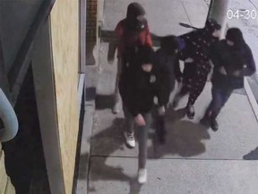 A surveillance camera image of five suspects in a group assault that occurred in downtown Windsor during the early hours of April 30, 2023.