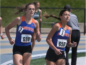 Sandwich Sabres' Juliet Gin, at right, races to victory in the WECSSAA novice girls' 800 metres while teammate Leah Shannon, at left, finishes third.