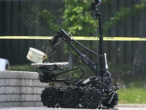 The robot of the Windsor police Explosive Disposal Unit picks up a cooking pot in a suspicious package investigation on May 23, 2023.