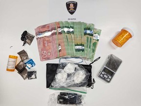 Cash, suspected cocaine, a digital scale, and capsules containing an unidentified white substance seized by Windsor police in an arrest operation on the night of May 18, 2023.