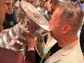 Vegas Golden Knights part owner Dale Wishewan drinks from the Stanley Cup.