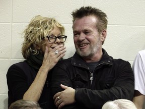 In this Dec. 31, 2011 file photo, Meg Ryan talks with John Mellencamp during the second half of an NCAA college basketball game between Indiana and Ohio State in Bloomington, Ind.