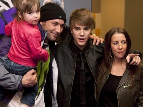 Justin Bieber, second from right, poses with, from left to right, sister Jazmyn, father Jeremy Bieber, and mother Pattie Lynn Mallette prior to the screening of his new film "Justin Bieber: Never Say Never" in Toronto Tuesday, Feb. 1, 2011.