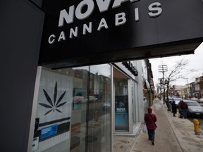 Signage for a cannabis dispensary is seen among other shops on Queen St. in Toronto, Monday, Jan. 6, 2020.