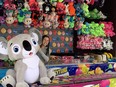 Carny holds large stuffed animal