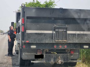 A LaSalle police officer speaks with a driver during a commercial vehicle inspection on June 6, 2023.