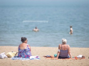 Sun worshippers endure the heat at Windsor's Sand Point Beach during the summer of 2022.