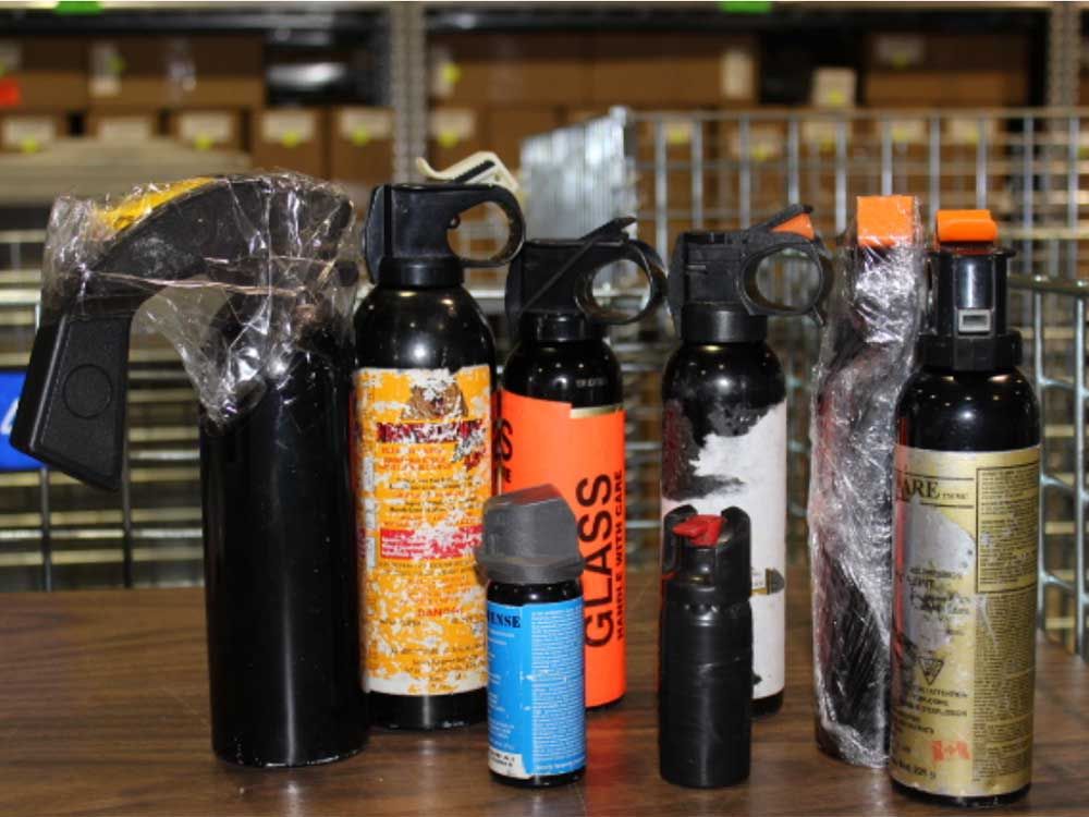 A variety of bear spray canister seized by Edmonton police in 2019. Note how some canisters have been tampered with in order to make them easier to use as a weapon.