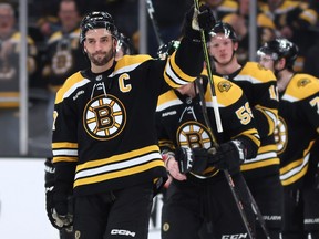 Patrice Bergeron #37 of the Boston Bruins waves to fans before exiting the ice after Florida Panthers defeat the Bruins 4-3 in overtime of Game Seven of the First Round of the 2023 Stanley Cup Playoffs at TD Garden on April 30, 2023.