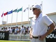 Fans watch as LIV Golf CEO Greg Norman looks on from the driving range before the first round of an LIV golf tournament at the Real Club Valderrama in San Roque, Spain, Friday, June 30, 2023.