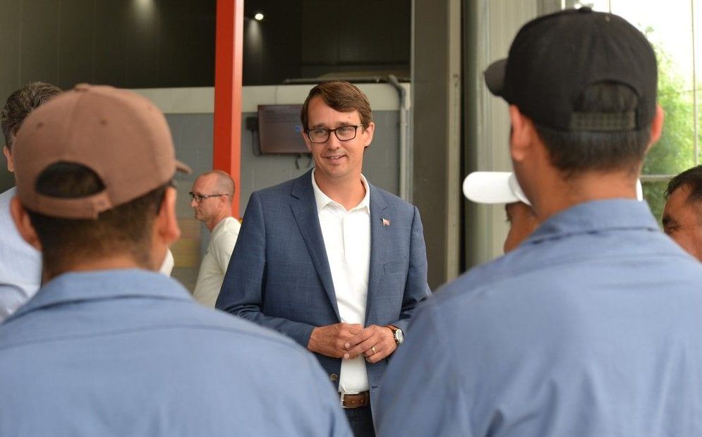 Monte McNaughton talks with workers