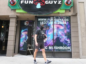 A Windsor police officer stands outside the FunGuyz location at 359 Ouellette Ave. in downtown Windsor on July 6, 2023.