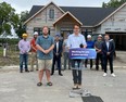 Monte McNaughton, Ontario's minister of labour, immigration, training and skills development, speaks during Friday's announcement in Dresden that the province will invest an additional $160 million in the Skills Development Fund. Shown at left is Phillip Mock, executive director at Vision Us. (Handout)