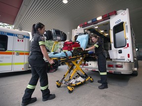 Paramedics load a stretcher