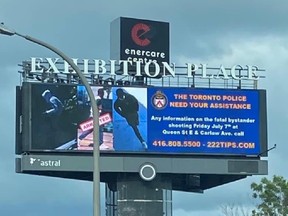 An electronic billboards displays images of the two suspects sought and one already charged in the Leslieville slaying of Karolina "Caroline" Huebner-Makurat on July 7, 2023.
