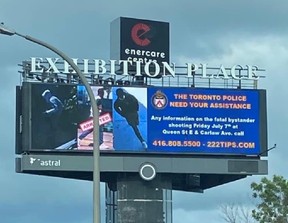 An electronic billboards displays images of the two suspects sought and one already charged in the Leslieville slaying of Karolina "Caroline" Huebner-Makurat on July 7, 2023.