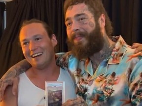 Collector Brook Trafton poses with rapper Post Malone who bought rare trading card from him.