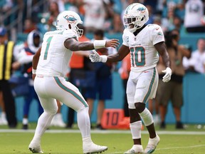 Tua Tagovailoa (left) of the Miami Dolphins and Tyreek Hill #10 of the Miami Dolphins celebrate after a Miami touchdown during the third quarter against the Denver Broncos.