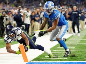 Seattle Seahawks' receiver Tyler Lockett scores in overtime to win the game over the Detroit Lions at Ford Field on Sunday.