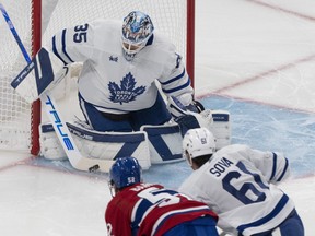 Toronto Maple Leafs goaltender Ilya Samsonov (35) makes a save against Montreal Canadiens' Justin Barron (52) as Leafs' Spencer Sova (61) skates in during first period NHL preseason hockey action in Montreal on Friday, Sept. 29, 2023.