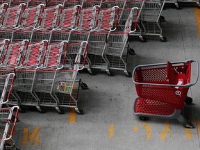 A Target shopping cart stands among other carts in a parking lot outside of Target's Harlem store in New York City.